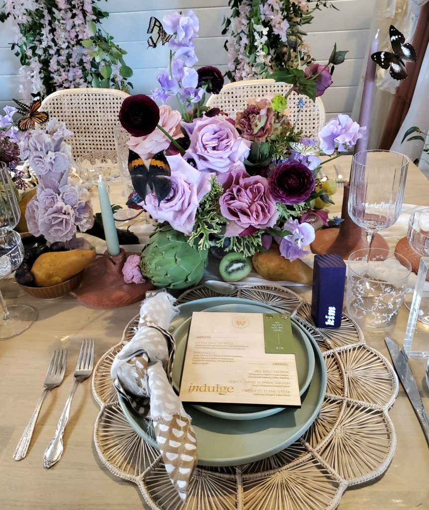 Wedding table with plates and flowers. 