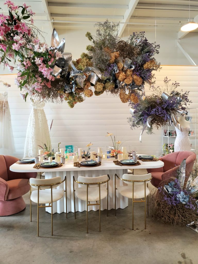 Wedding reception table design with hanging floral installation. 