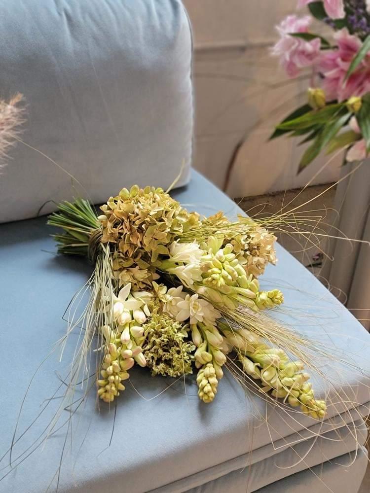 Small bridal bouquet on chair. 